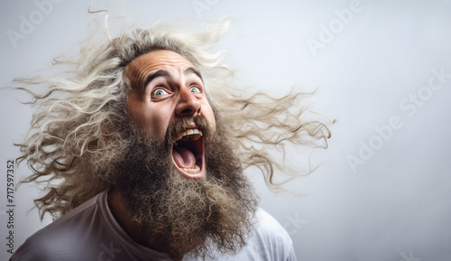 Isolated portrait of angry mad young man with long beard shouting. Concept of fundamentalism and anger management. Mock up photo