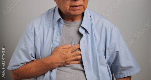 Asian old man has difficulty breathing. An elderly man has dyspnea.