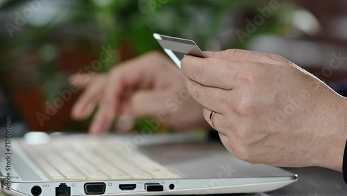 Asian middle-aged man's hands entering credit card information