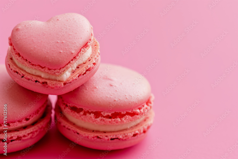 Pink heart shaped macarons on a pastel ink background. Valentines day tasty treats