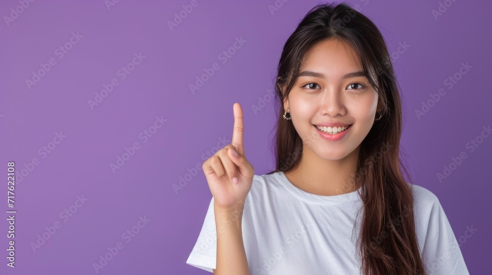 A woman with long brown hair holding up a peace sign. This image can be used to symbolize peace, unity, or activism A woman with long brown hair holding up a peace sign. This image can be used to symbolize peace, unity, or activism