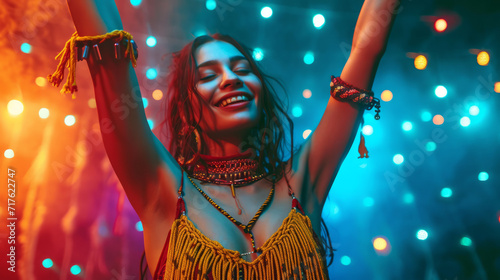 Beautiful uninhibited young woman wearing macrame clothes dancing in a nightclub with neon colors lights photo