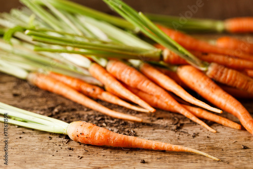 Fresh carrots on wooden table.