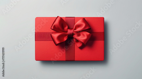 Red gift box with red ribbon and bow on light gray background, Valentines day, Birthday, Top view