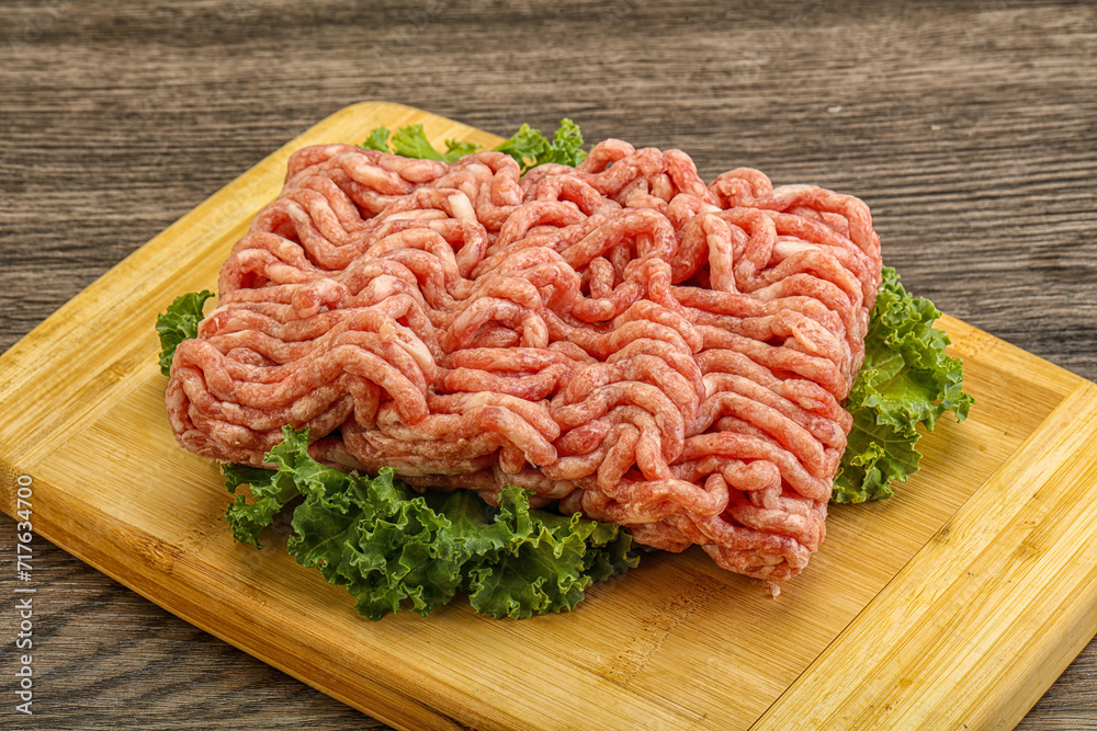 Raw pork minced meat over board