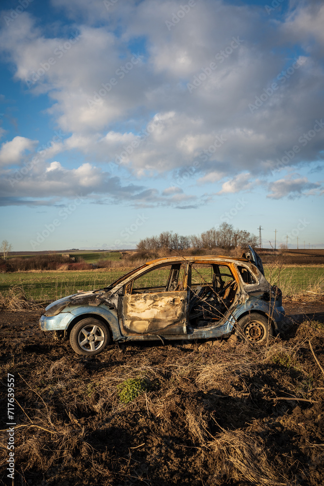 burned car wreck near to highway