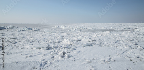 Winter landscape - frozen sea surface with snow.