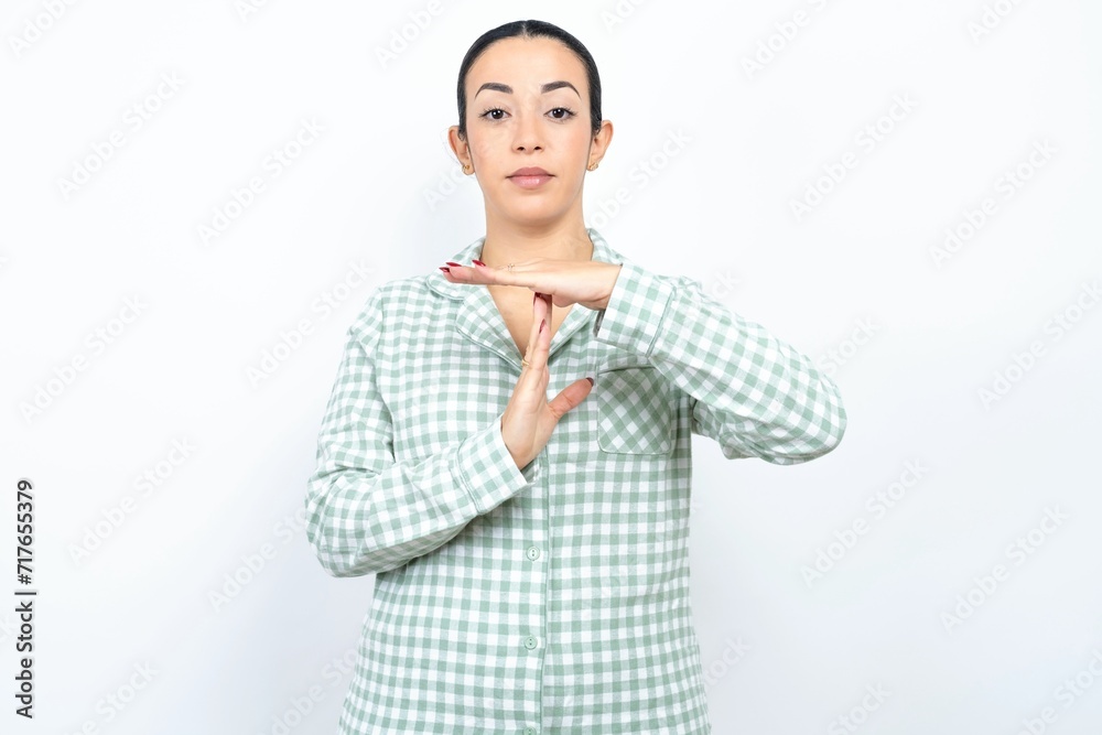 Beautiful young woman wearing green plaid pyjama and holding a cup being upset showing a timeout gesture, needs stop, asks time for rest after hard work, Beautiful young woman wearing green plaid pyjama and holding a cup being upset showing a timeout gesture, needs stop, asks time for rest after hard work,