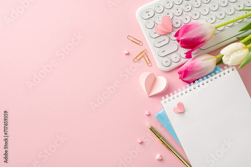 Send love to the accomplished businesswoman on Woman's Day! Top view keyboard, fresh tulips, hearts, diaries, and stationery create a festive setting on a pastel pink background