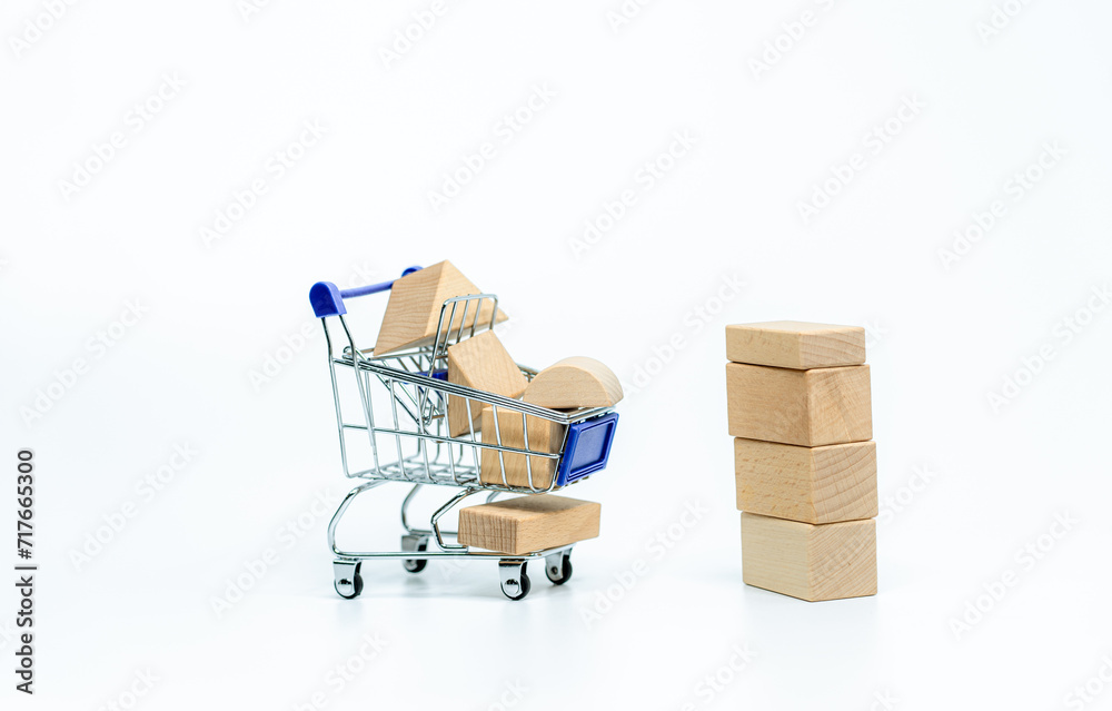 Wooden doll with shopping cart on white background. business or creative concept