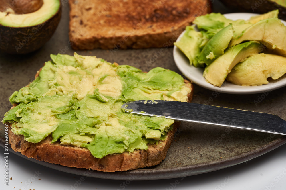 Fresh avocado on toast on white background