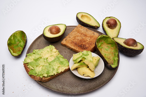 Fresh avocado on toast on white background