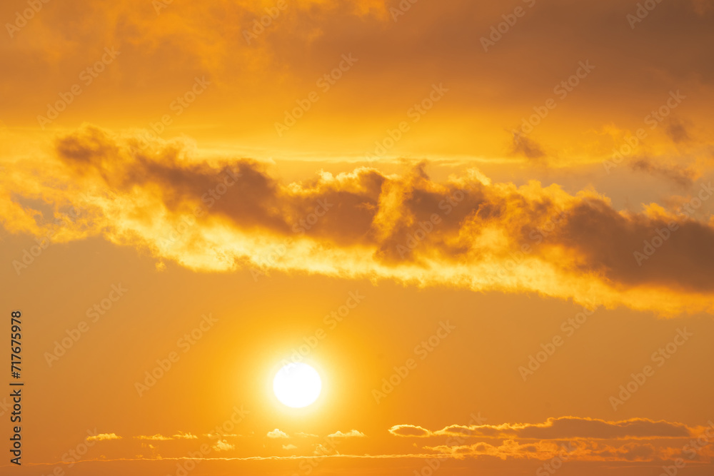 winter evening, sunset in yellow, orange and pink with clouds, background