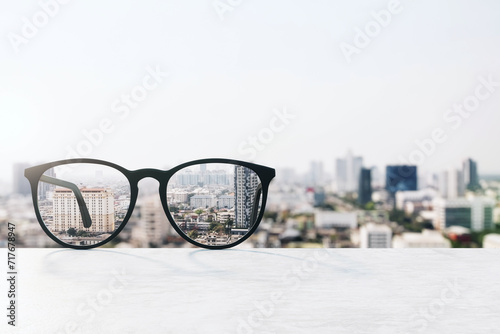 Conceptual image of glasses focusing on urban landscape, clarity in vision and perception