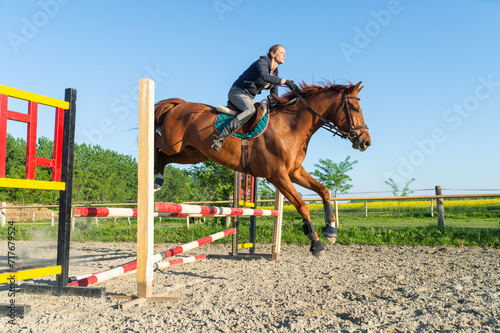 Jockey jumps over a hurdle © Dusan Kostic