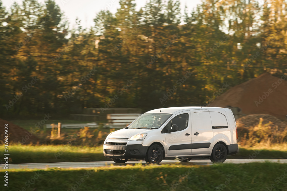 A commercial van truck on the highway, delivering goods and products across the country, using fast and reliable modes of freight transportation. A commercial van truck on the highway, delivering goods and products across the country, using fast and reliable modes of freight transportation.