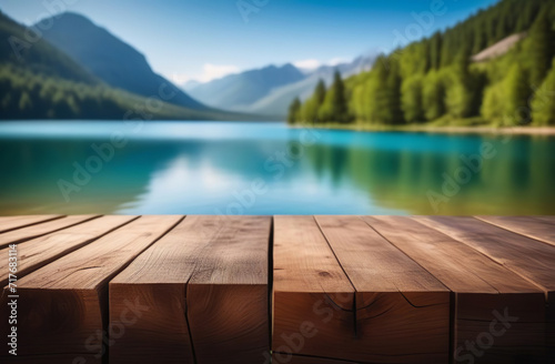 Empty wooden tabletop with blur background of summer lakes mountain. Perspective wood display on lake view. Beautiful rock glacier fresh landscape scenery  plank table blank board for product montage