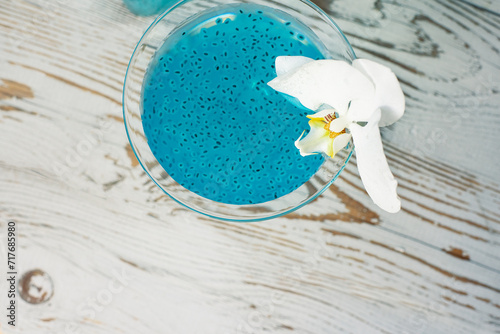 Cocktail with flavored ice with chia seeds on a light wooden background. slushy drink photo