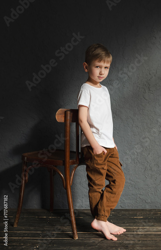 blond boy in a white T-shirt, blurred background, bokeh