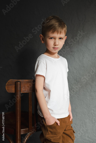 blond boy in a white T-shirt, blurred background, bokeh