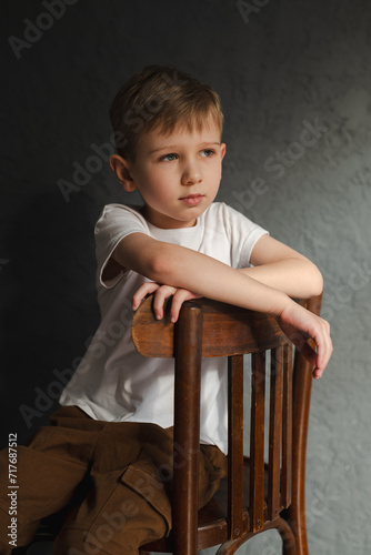blond boy in a white T-shirt, blurred background, bokeh