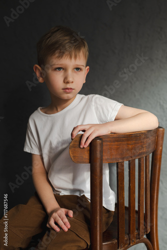 blond boy in a white T-shirt, blurred background, bokeh