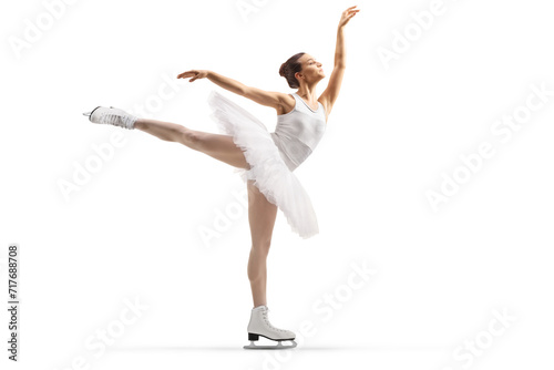 Full length profile shot of a female ice figure skater performing