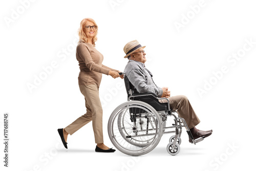 Woman pushing an elderly gentleman in a wheelchair