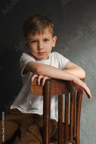 blond boy in a white T-shirt, blurred background, bokeh