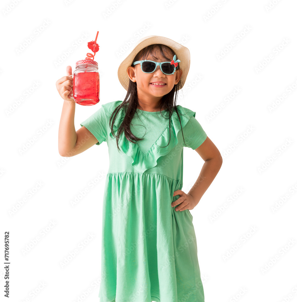 Happy Asian little girl posing with wear a hat and sunglasses holding glass of red sweet water, Holiday summer fashion green dress, isolated on white background