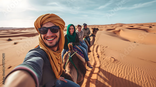 Happy tourist having fun enjoying group camel ride tour in the desert - Travel, life style, vacation activities and adventure concept