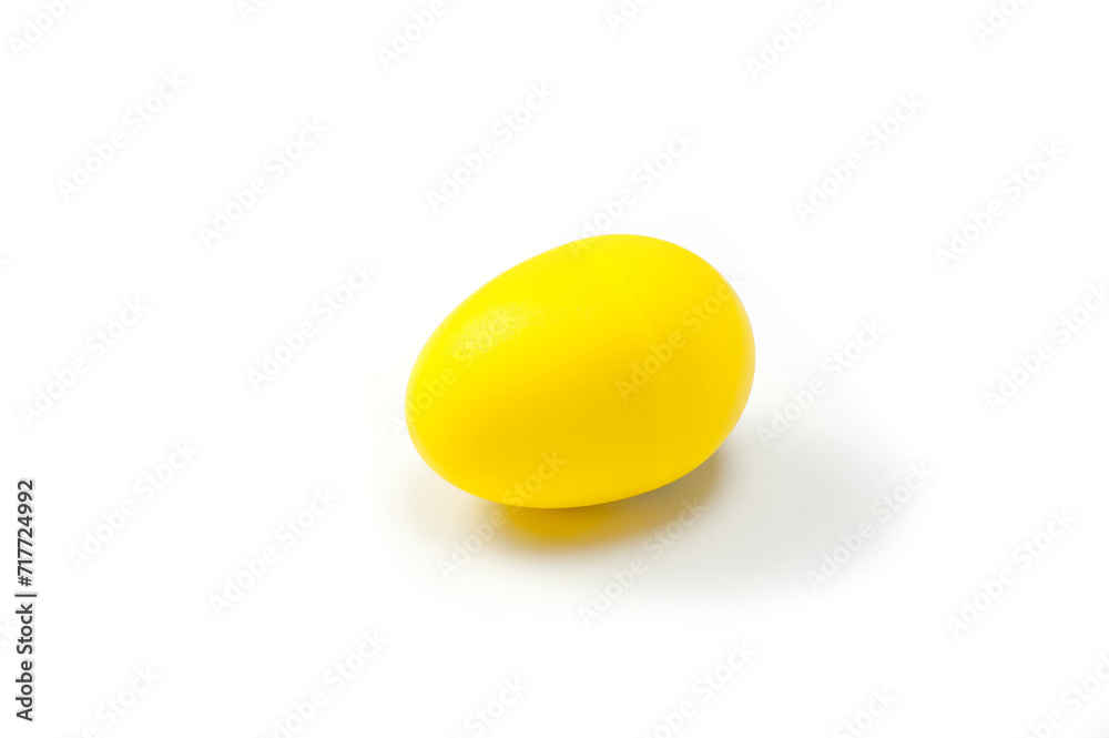 A yellow, egg-shaped, plastic shaker, a musical instrument used in different styles of music. A yellow, egg-shaped, plastic shaker, a musical instrument used in different styles of music.