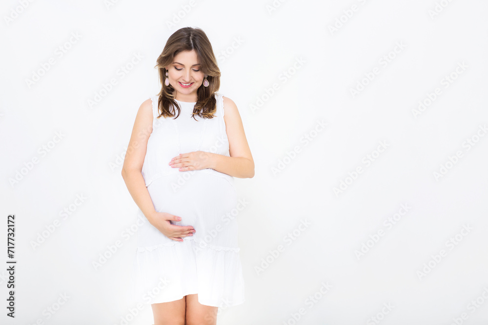 Pretty pregnant woman indoors on white background Pretty pregnant woman indoors on white background