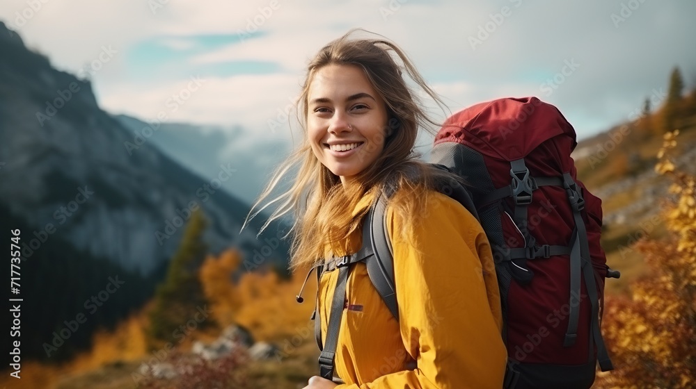 Rear view of a woman walking up a mountain.woman with backpack travels in the mountains