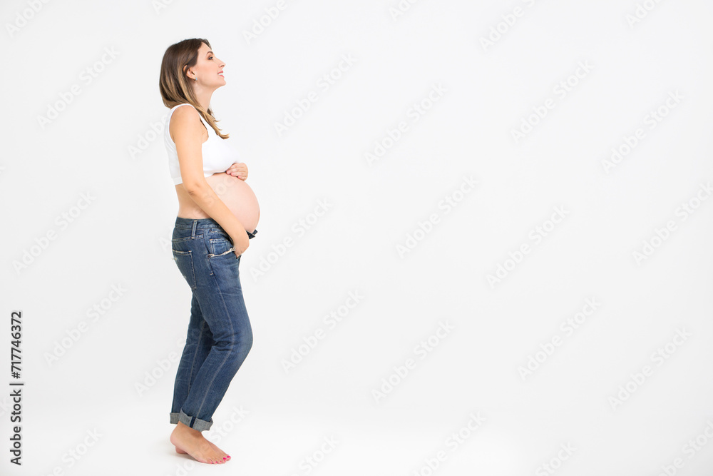 Pretty pregnant woman indoors on white background