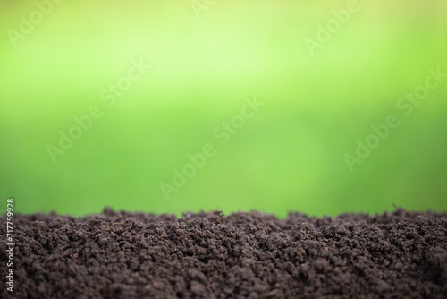 pile of soil with blurred green background