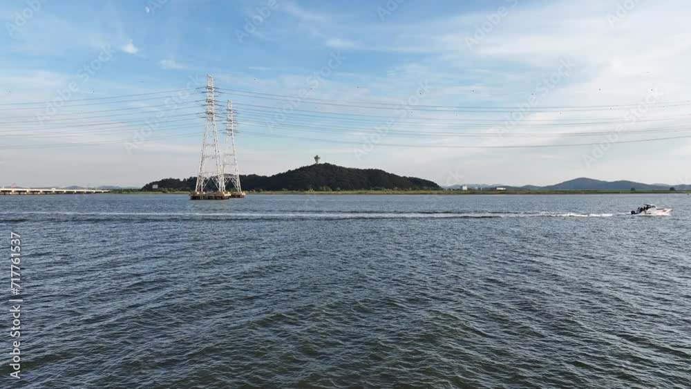Transmission tower on the sea and a boat sailing on the sea
Transmission tower on the sea and a boat sailing on the sea