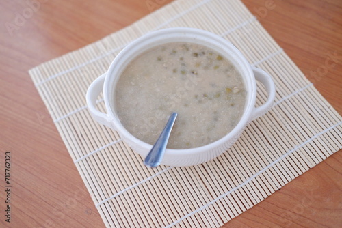 Mung Bean Porridge or Bubur Kacang Hijau, Indonesian dessert porridge of mung beans with coconut milk, pandan leaf and ginger. Served in bowl.