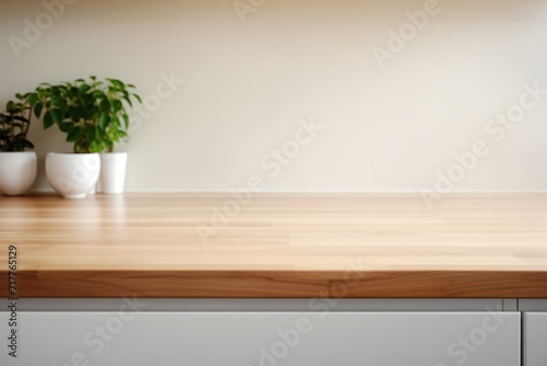 an empty wooden table against a white wall in the kitchen. a mockup, a workplace for cooking. copy space.