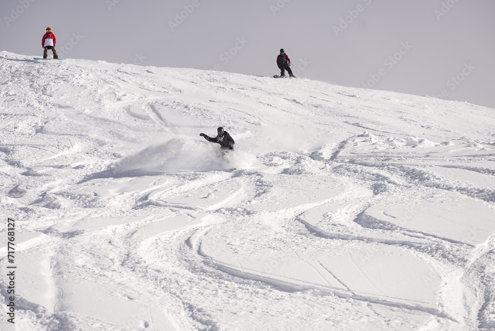 Freeride powder, snowboarding in Les deux alpes resort in winter, mountains in French alps, Rhone Alpes in France Europe