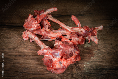 raw cow beef parts on wooden background. Fresh beef parts for sale. Food for dog photo