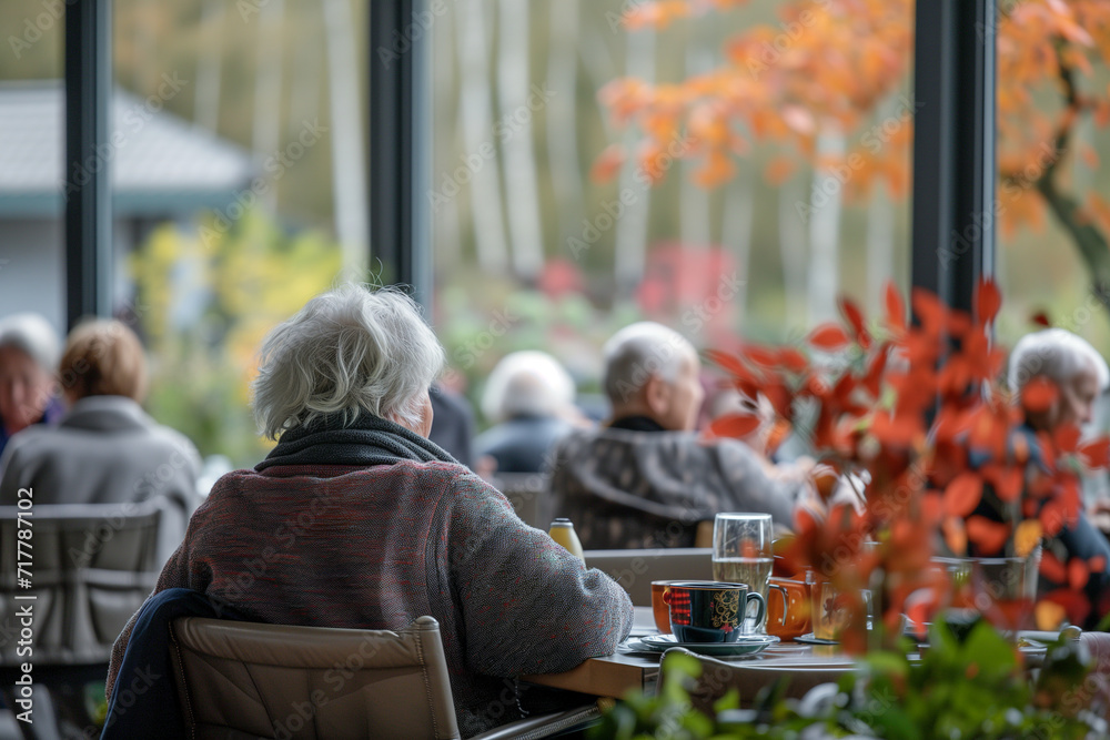 Group of old people eating in a retirement home