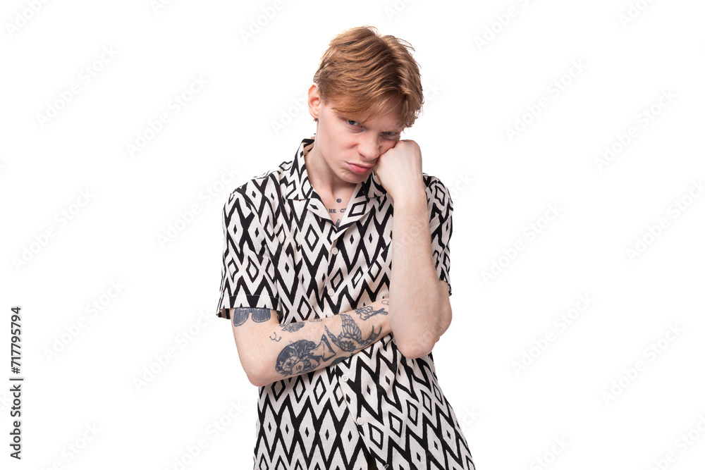young tired upset man with red hair dressed in a short sleeve shirt posing on a white background young tired upset man with red hair dressed in a short sleeve shirt posing on a white background