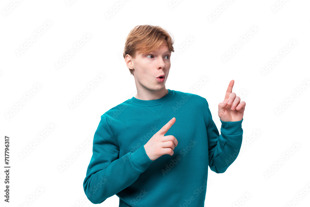 close-up portrait of a student guy with red hair, a guy dressed in a blue sweater looking in surprise to the side