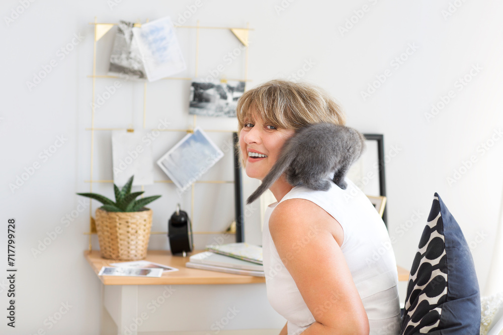 Kitten sitting on the sholder of a mature woman Kitten sitting on the sholder of a mature woman