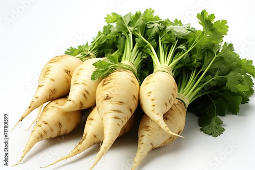 White and still small parsley root with green fresh leaves isolated .