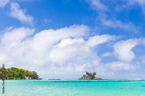 Anse Royale, Seychelles. Coastal view with small island under blue sky