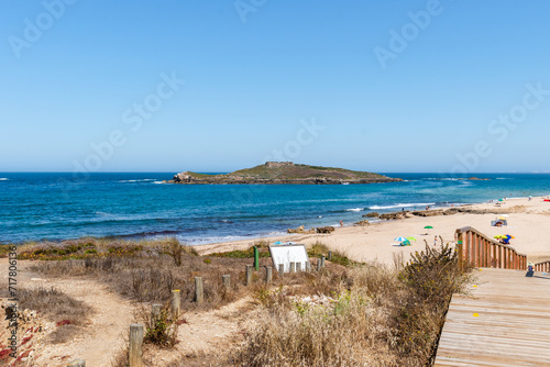 Wooden pathway and trail at Porto Covo beach and Pessegeurio island in background, Sines PORTUGAL photo