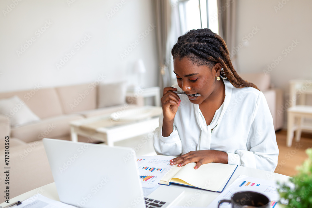 Beautiful woman freelancer noting information for planning project doing remote job via laptop computer. woman laughing while reading email on modern laptop device . Beautiful woman freelancer noting information for planning project doing remote job via laptop computer. woman laughing while reading email on modern laptop device .