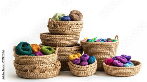 A stack of woven baskets, in varying sizes and natural textures, overflowing with colorful yarn skeins,